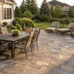 20x20 patio cost 2026 — large finished paver patio with outdoor dining set in backyard